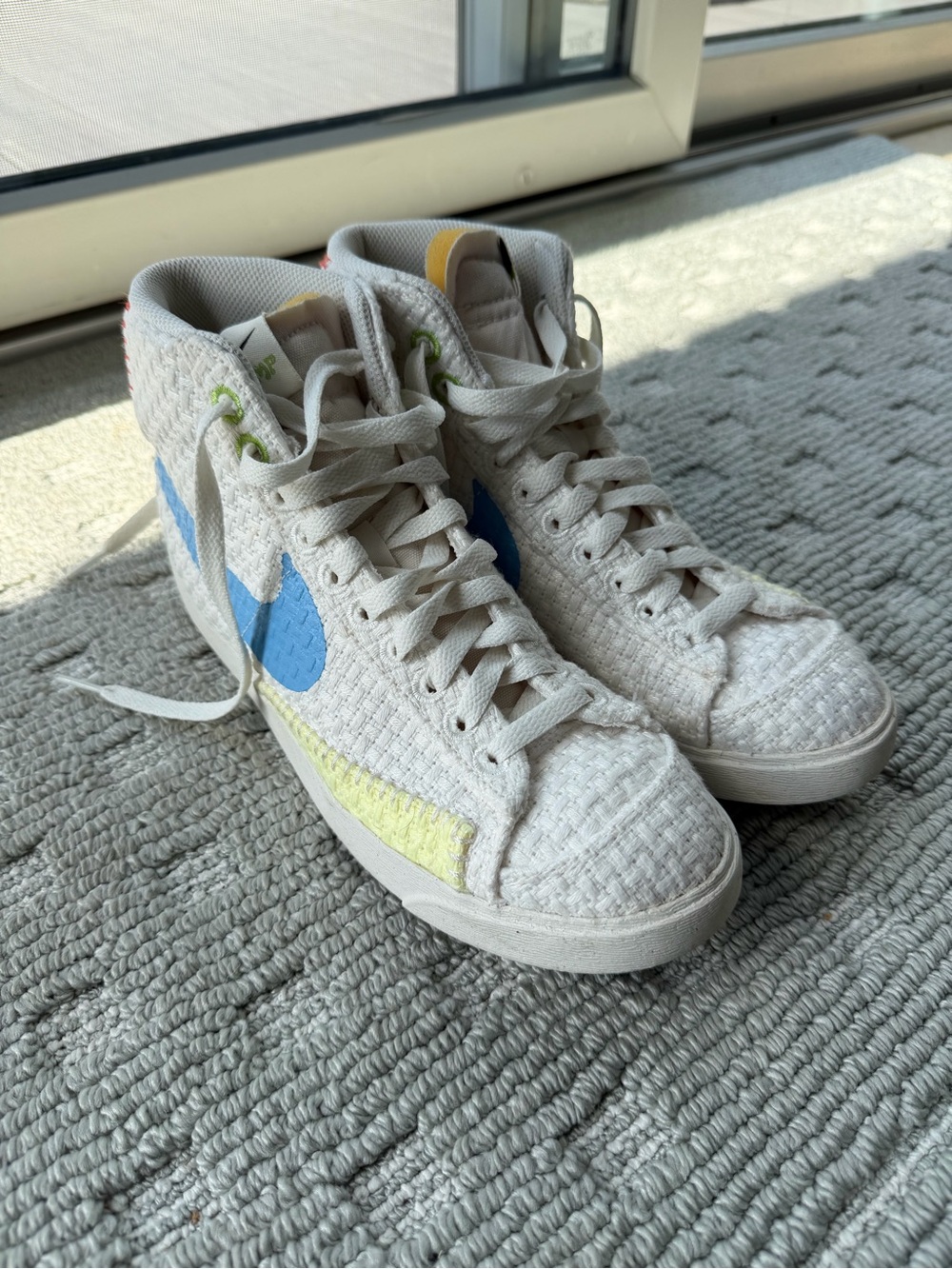 Nike White High-Top Sneakers with Blue Swoosh and Yellow Accent